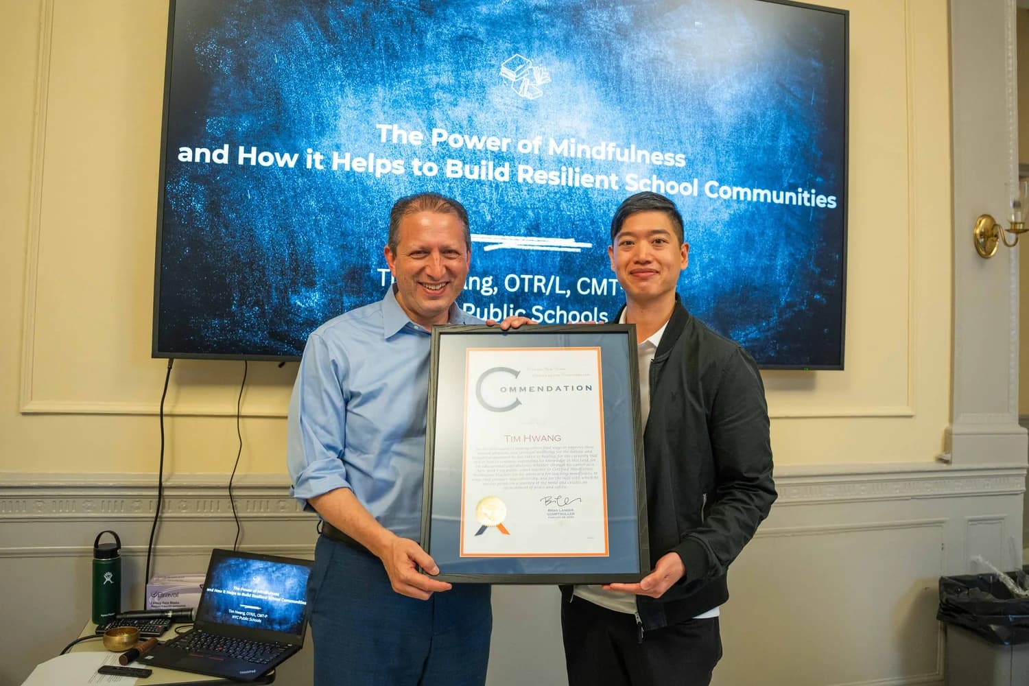 Tim Hwang with NYC Comptroller Brad Lander holding a commendation